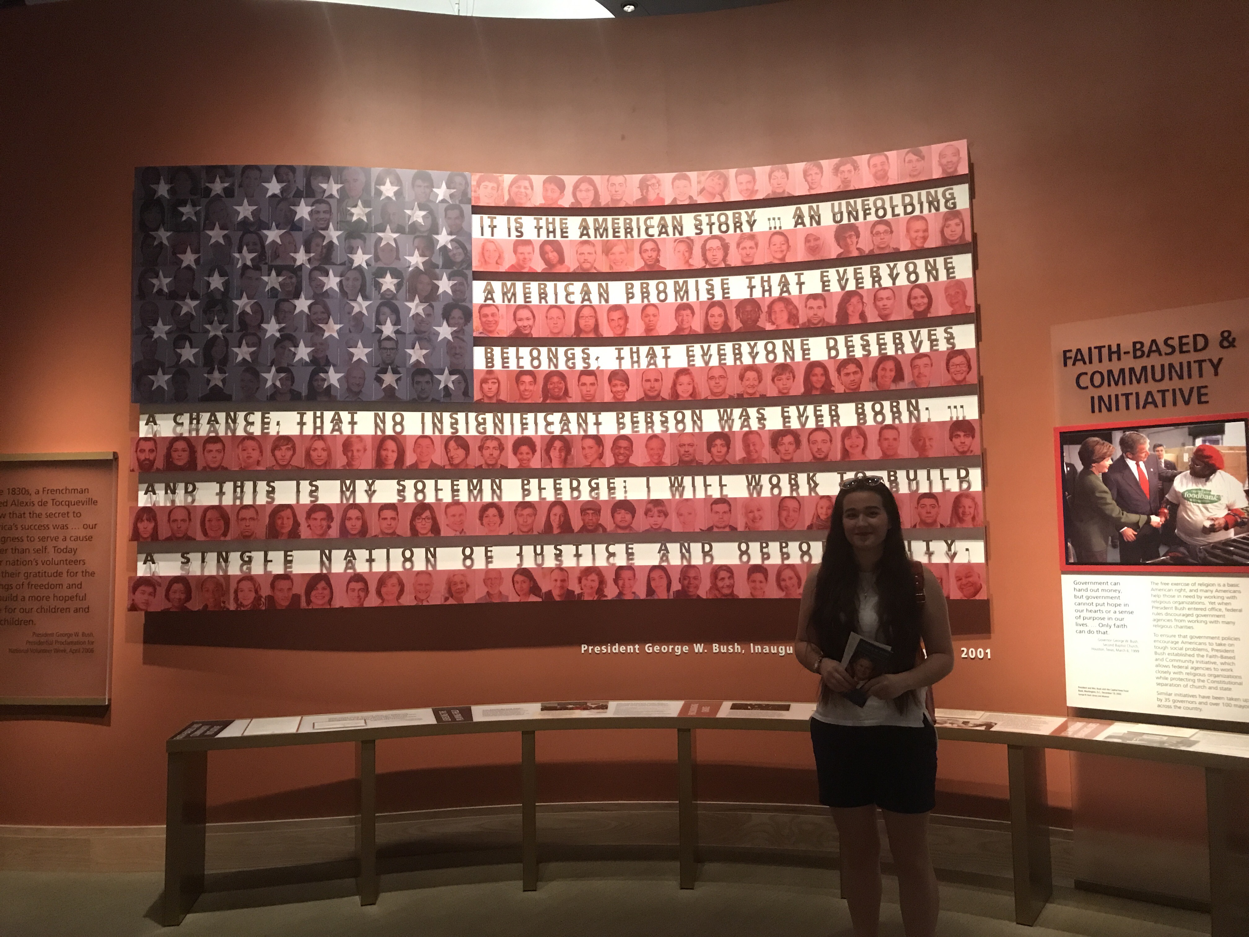 Katerine in front of the American flag at a museum.