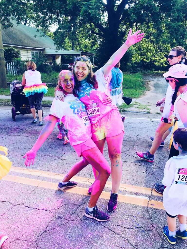 Tove and her friend after participating in a Holy Festival / Colour Run, covered in pink colour.
