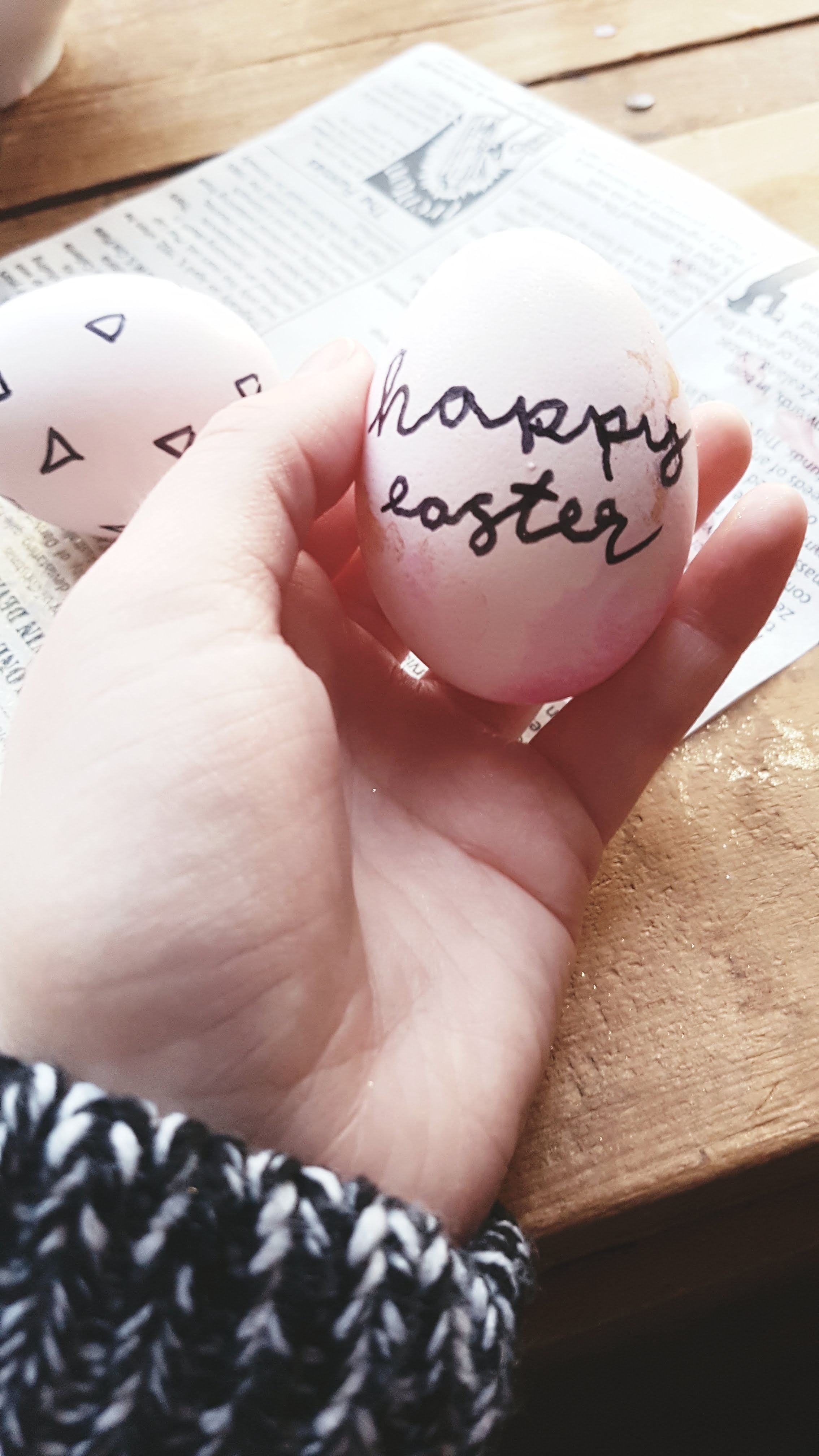 An egg that has "Happy Easter" written on it.