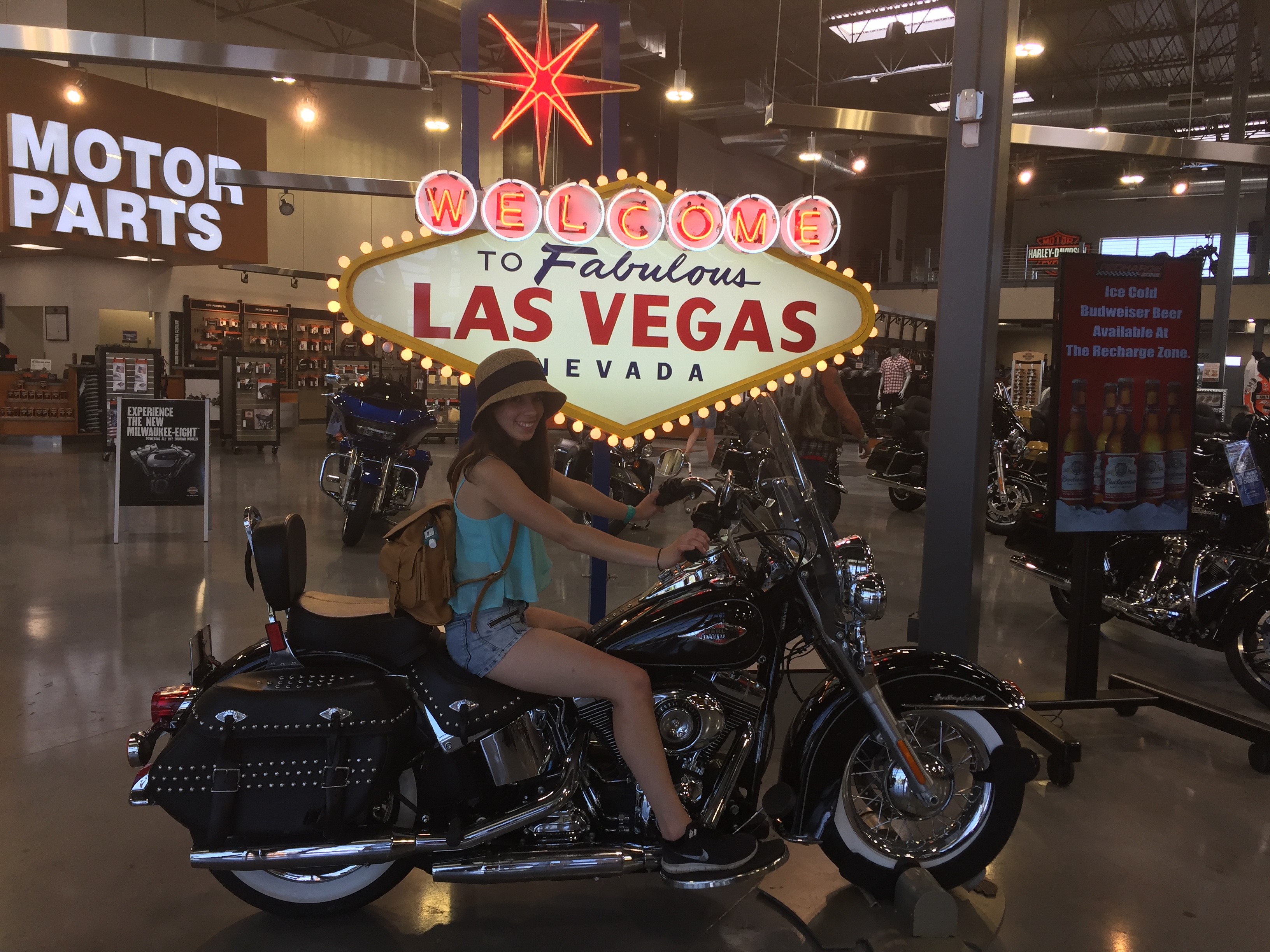 Maria on a Harley Davidson in front of a replica of the infamous Las Vegas sign.